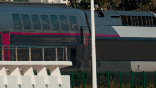 Video - Cannes, France - October 10, 2025: Close up of a modern French train moving along the railway near the coast