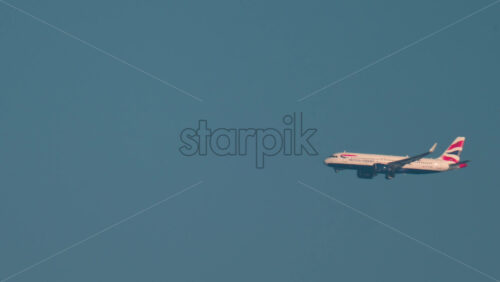 Video - Cannes, France - October 10, 2025: A British Airways airplane flies smoothly through a cloudless sky over the Mediterranean