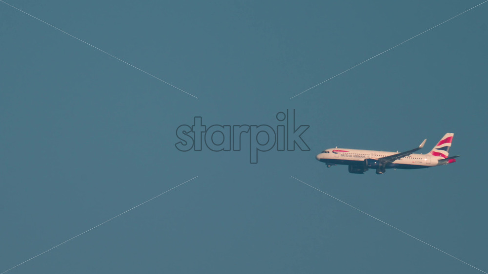 Video - Cannes, France - October 10, 2025: A British Airways airplane flies smoothly through a cloudless sky over the Mediterranean