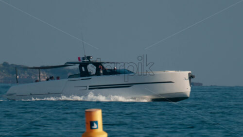 Video - A sleek modern yacht speeds across the blue Mediterranean waters near the French Riviera