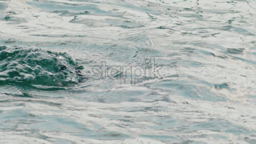 Video - A cormorant swims and dives into the clear blue sea near the coast