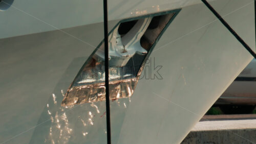 Video - A detailed close up of a yacht's metal anchor shining under the afternoon sun in Cannes Marina