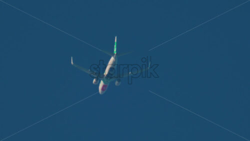 Video - Cannes, France - October 11, 2025: An airplane passes overhead in a clear blue sky, seen from below