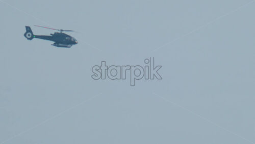 Video - Cannes, France - October 11, 2025: Two workers wearing protective white suits and respirators sand and repair the hull of a boat in dry dock