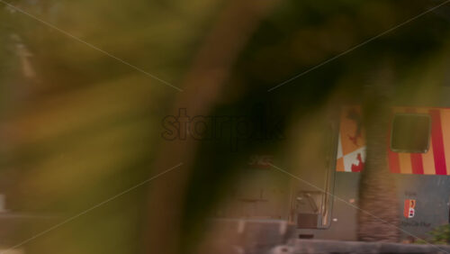 Video - Cannes, France - October 12, 2025: A regional SNCF train travels along the coastal tracks near Cannes, with palm trees and beachgoers visible below