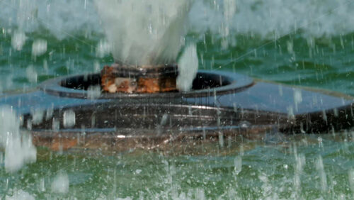 Video - Close up of a fountain nozzle spraying water with powerful jets