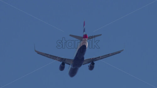 Video - Cannes, France - October 12, 2025: A commercial airplane flying overhead with clear blue sky
