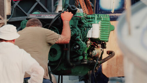 Video - Cannes, France - October 12, 2025: A mechanic working on a marine engine at the port