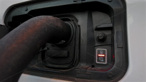 Video - Close up of an electric vehicle charging connector with illuminated green indicator lights