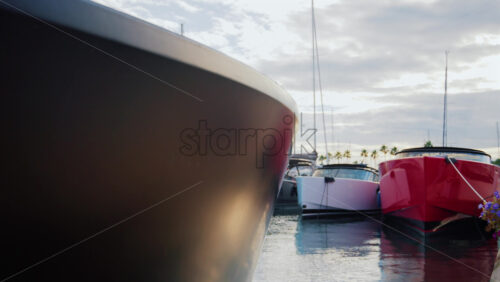 Video - Modern red and white yacht docked in calm marina waters with clear reflections