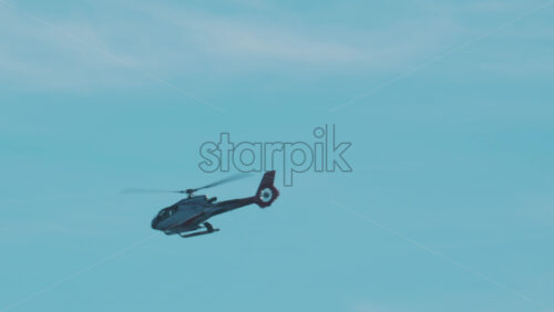 Video - Cannes, France - October 13, 2025: Close up of helicopter gliding above layered blue mountains under soft daylight