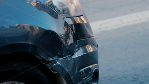 Video - Close up of a scratched and dented car bumper on the street