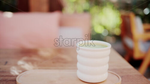 Video - Wooden restaurant table prepared with glasses, plates, and napkins in warm natural light