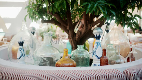Video - Wooden restaurant table prepared with glasses, plates, and napkins in warm natural light