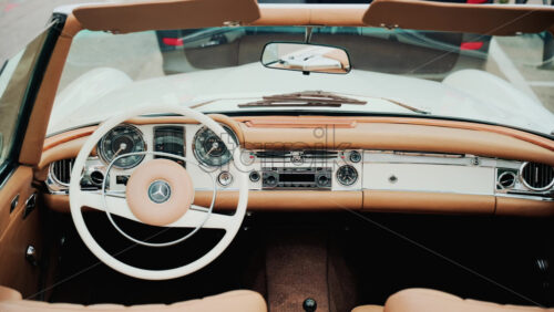 Video - Cannes, France - October 13, 2025: Close up view of a classic Mercedes convertible car interior with beige leather seats and chrome dashboard details