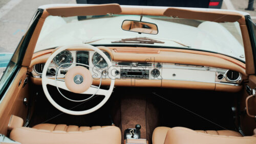 Video - Cannes, France - October 13, 2025: Close up view of a classic Mercedes convertible car interior with beige leather seats and chrome dashboard details