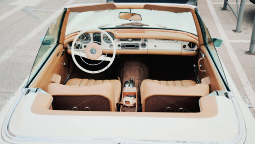 Video - Cannes, France - October 13, 2025: Close up view of a classic Mercedes convertible car interior with beige leather seats and chrome dashboard details