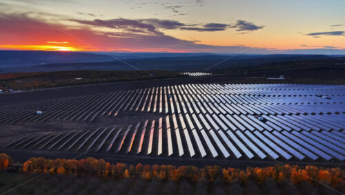Video – Aerial drone view of a large solar panel field in Moldova at sunset - Starpik Stock