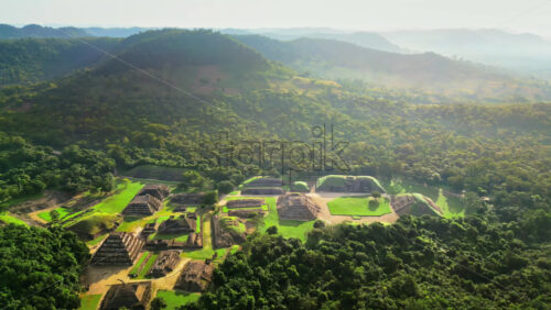 Video – Aerial drone view of ancient Mayan ruins hidden within a dense green jungle in slow motion - Starpik Stock