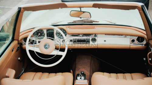 Video – Cannes, France – October 13, 2025: Close up view of a classic Mercedes convertible car interior with beige leather seats and chrome dashboard details - Starpik Stock
