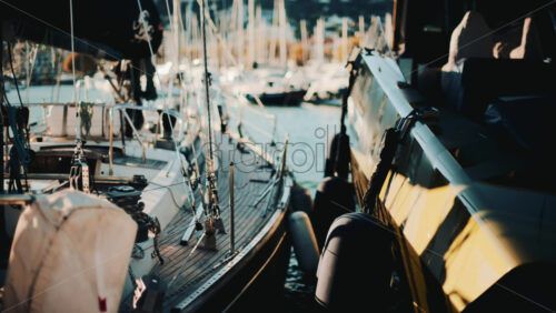 Video – Close view of yachts and sailboats docked side by side in a scenic marina during golden hour - Starpik Stock