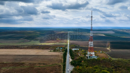 Video - Aerial drone view of an electricity tower in the middle of a filed, near a road in Moldova time lapse
