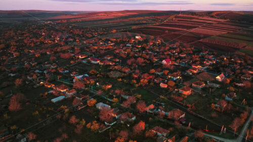 Video - Aerial drone view of a Moldovan village illuminated by warm golden hour sunlight