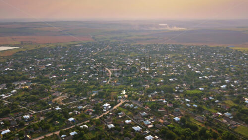 Video - Aerial drone view of a Moldovan village with small houses, gardens, and narrow streets surrounded by greenery