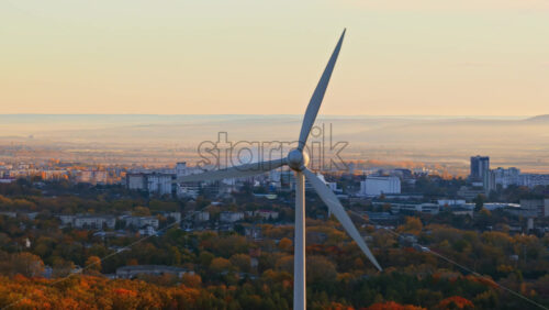 Video - Aerial drone view of a wind turbine overlooking a Moldovan city in autumn