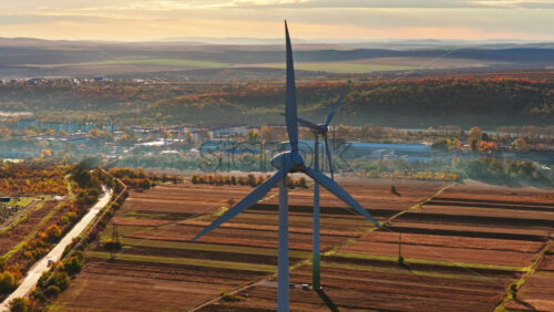 Video - Aerial drone view of a wind turbine overlooking a Moldovan city in autumn