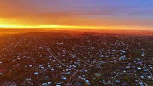 Video - Aerial drone view of a Moldovan town under a glowing orange sunset