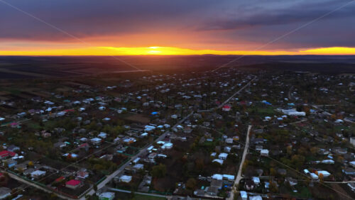 Video - Aerial drone view of a Moldovan town under a glowing orange sunset