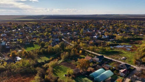Video - Aerial drone view of a Moldovan village surrounded by green fields and gentle hills