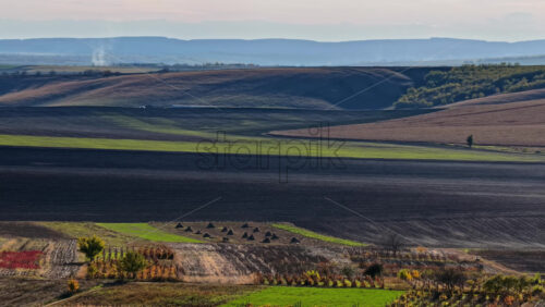 Video - Aerial drone view of a Moldovan village surrounded by green fields and gentle hills