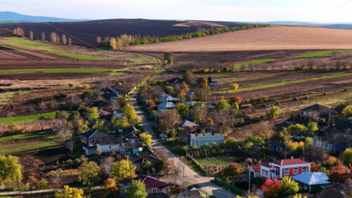 Video - Aerial drone view of a Moldovan village surrounded by green fields and gentle hills