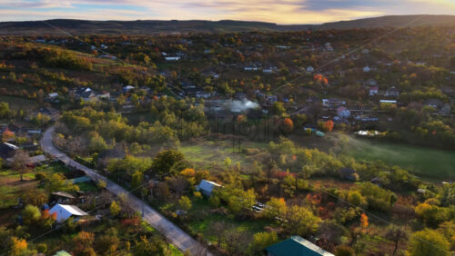 Video - Aerial drone view of a Moldovan village surrounded by green fields and gentle hills
