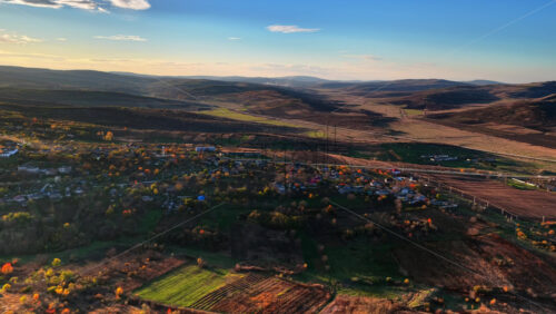 Video - Aerial drone view of a Moldovan village surrounded by green fields and gentle hills