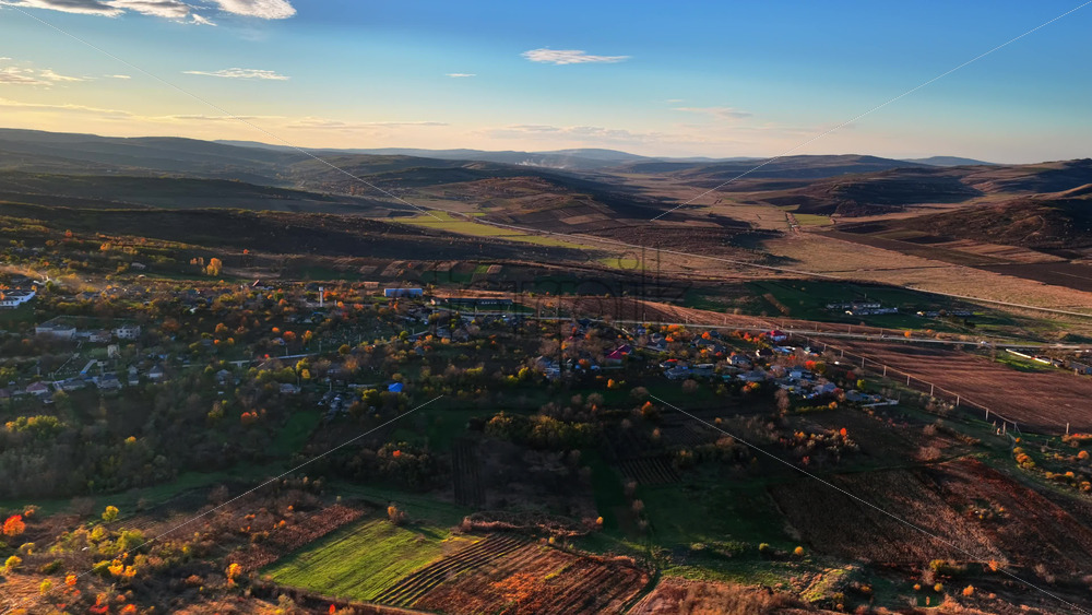 Video - Aerial drone view of a Moldovan village surrounded by green fields and gentle hills