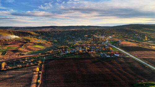 Video - Aerial drone view of a Moldovan village surrounded by green fields and gentle hills