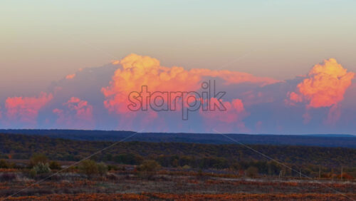 Video - Aerial drone view of soft pink clouds above autumn vineyards and fields in rural Moldova