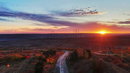 Video - Aerial drone view of a winding road through Moldovan hills at sunset