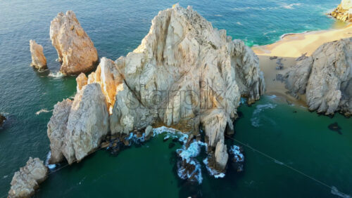 Video - Aerial drone view of the dramatic rocky formations and turquoise waters around Land's End in Cabo San Lucas