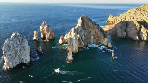 Video - Aerial drone view of the dramatic rocky formations and turquoise waters around Land's End in Cabo San Lucas
