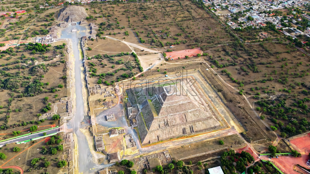 Video - Aerial drone view of the ancient Teotihuacan pyramids with the surrounding Mexican town and mountain landscape