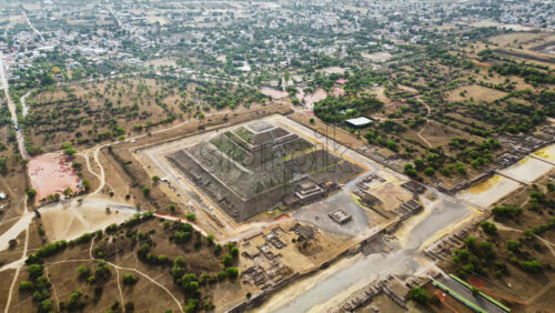 Video - Aerial drone view of the ancient Teotihuacan pyramids with the surrounding Mexican town and mountain landscape