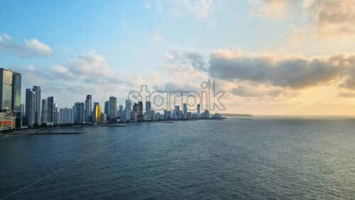 Video - Aerial drone view of Cartagena's modern skyline along the Caribbean coast at golden hour