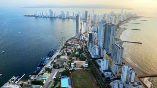 Video - Aerial drone view of Cartagena's coastal skyline with beaches, residential towers, and the shimmering Caribbean Sea in the background
