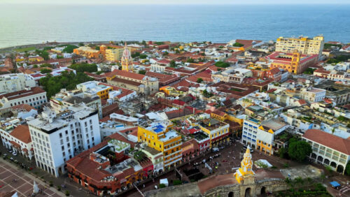 Video - Aerial drone view of Cartagena's famous walled city, highlighting its colonial architecture, domed cathedral, and historic streets by the Caribbean Sea