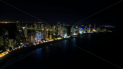 Video - Aerial drone view showing Cartagena's glittering skyline along the Caribbean coast at night