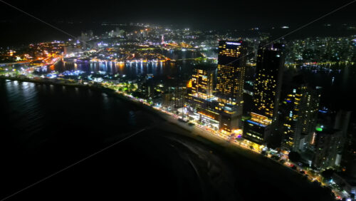 Video - Aerial drone view showing Cartagena's glittering skyline along the Caribbean coast at night